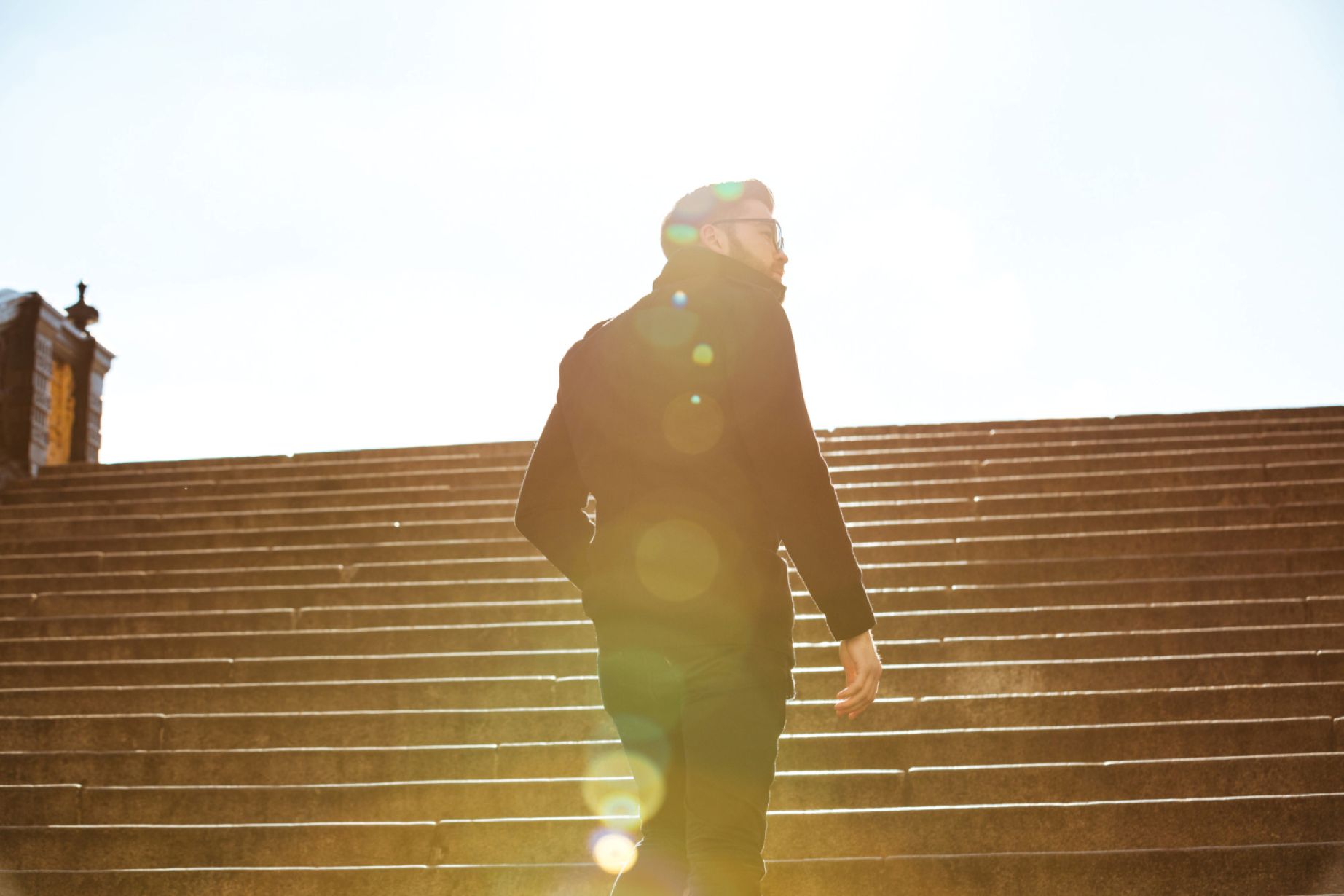 A man climbing up the steps with purpose.