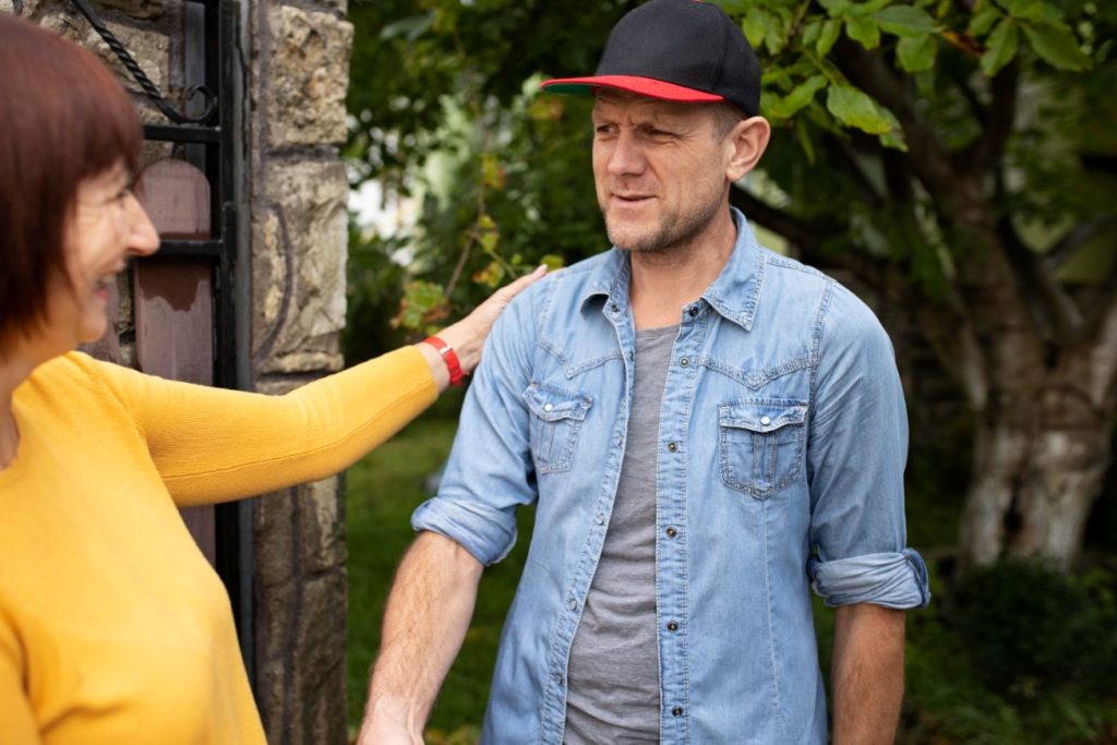 A man and a woman having just helped each other.
